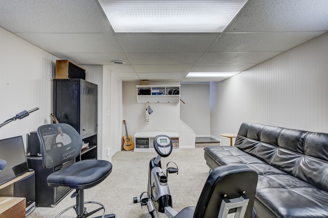 workout room with carpet and a drop ceiling