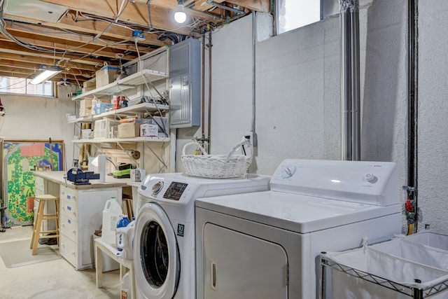 clothes washing area with separate washer and dryer and sink