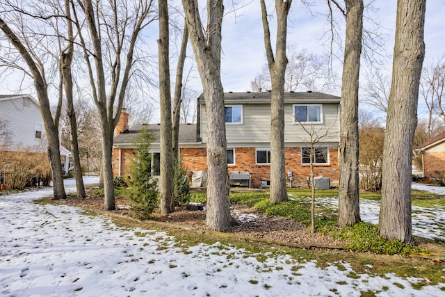 view of snow covered rear of property