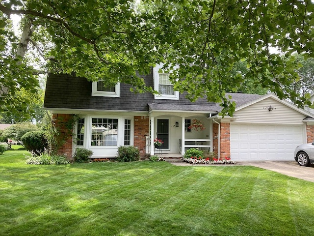 view of front of home with a garage and a front lawn