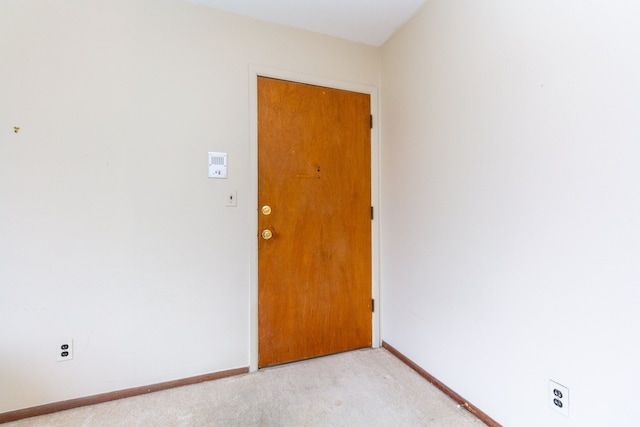 empty room with light colored carpet