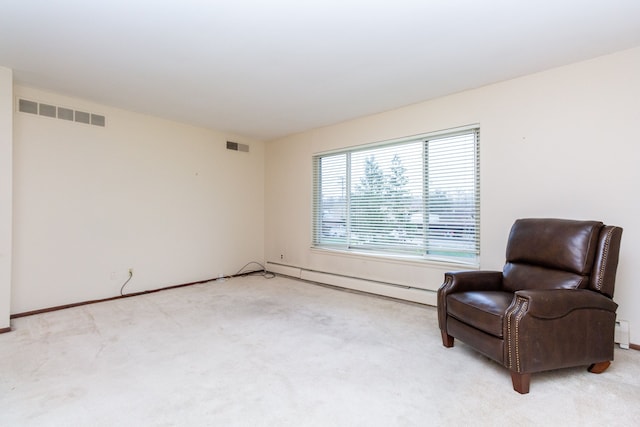 living area featuring a baseboard radiator and light colored carpet