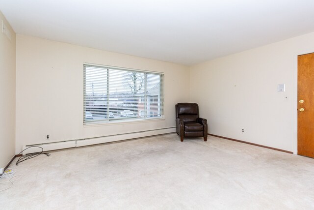 unfurnished room with light carpet and baseboard heating