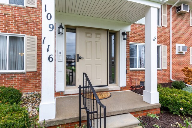 property entrance featuring an AC wall unit