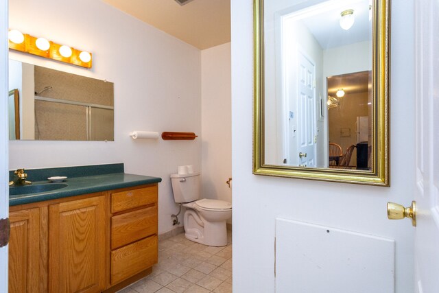 bathroom featuring tile patterned flooring, vanity, and toilet