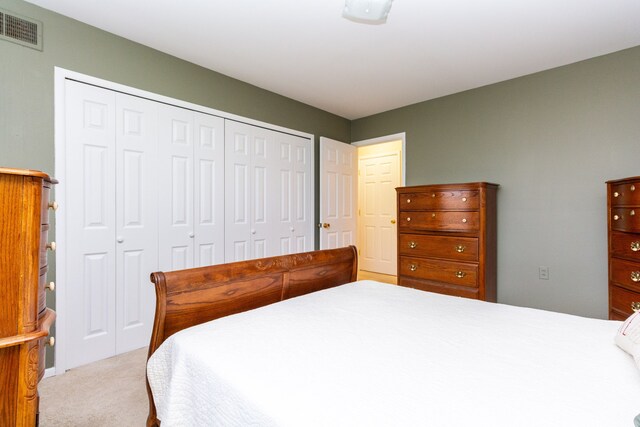 bedroom featuring a closet and light carpet