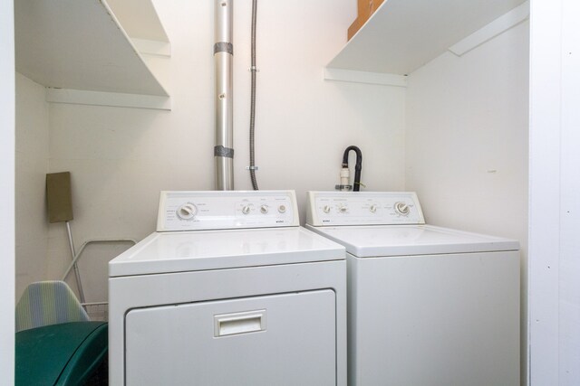 clothes washing area with separate washer and dryer