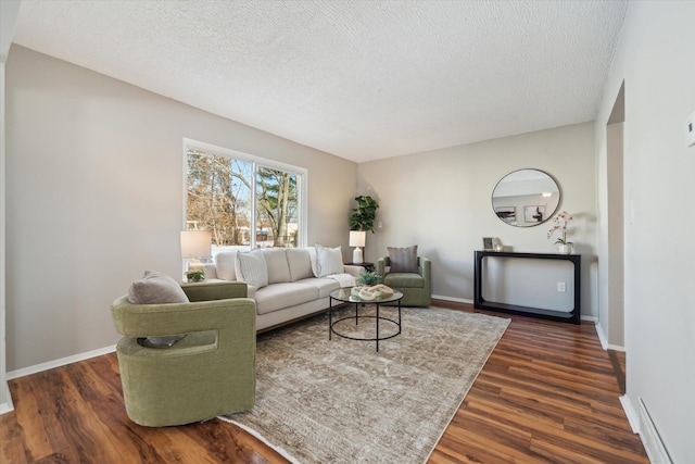 living room with dark hardwood / wood-style flooring and a textured ceiling