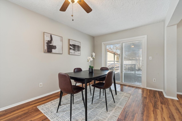 dining area featuring ceiling fan, dark hardwood / wood-style floors, and a textured ceiling