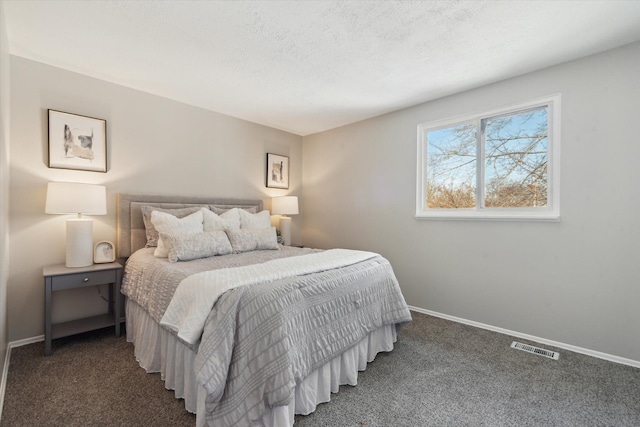 carpeted bedroom with a textured ceiling