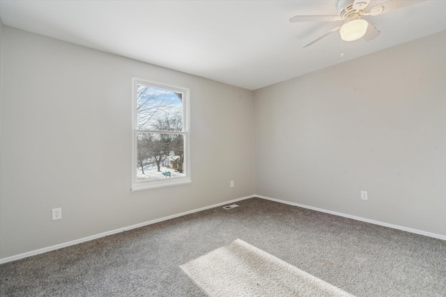 unfurnished room with ceiling fan and carpet