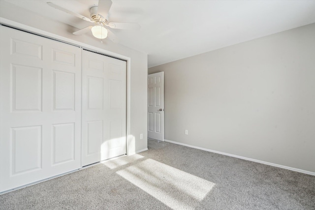 unfurnished bedroom featuring light colored carpet, a closet, and ceiling fan