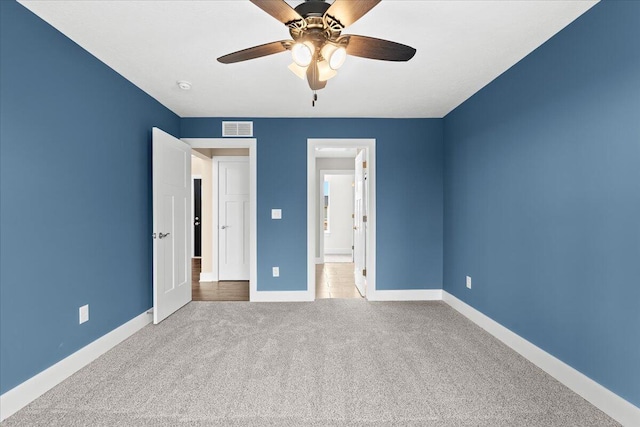 unfurnished bedroom featuring ceiling fan and light carpet