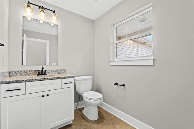 bathroom with vanity, toilet, and tile patterned flooring