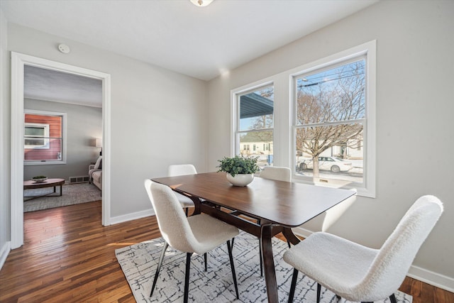 dining area featuring dark wood-type flooring