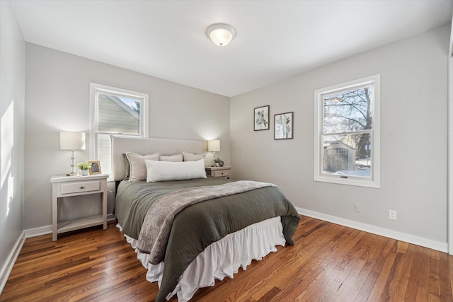 bedroom featuring multiple windows and dark hardwood / wood-style floors