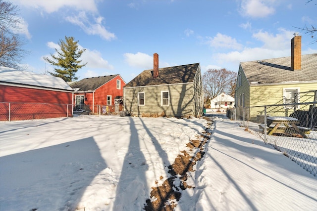 view of snow covered rear of property