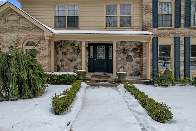 view of snow covered property entrance