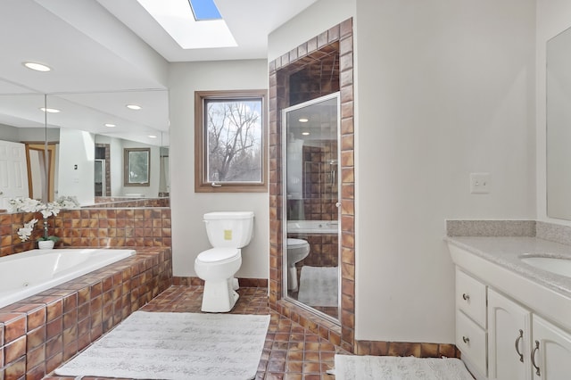 full bathroom with separate shower and tub, vanity, toilet, and a skylight