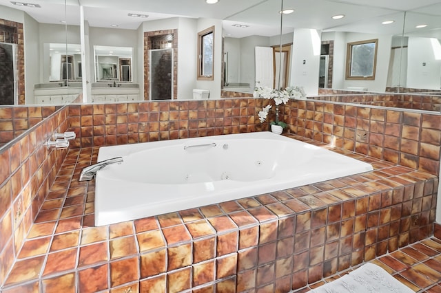 bathroom featuring a tub with jets, recessed lighting, and a stall shower