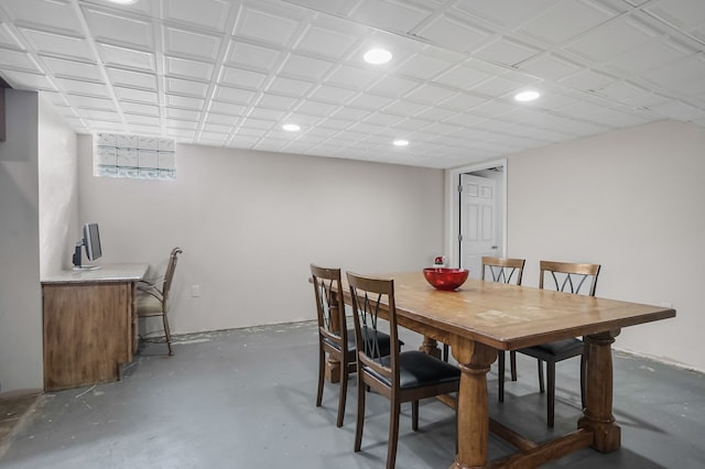 dining space with concrete floors, bar area, and recessed lighting