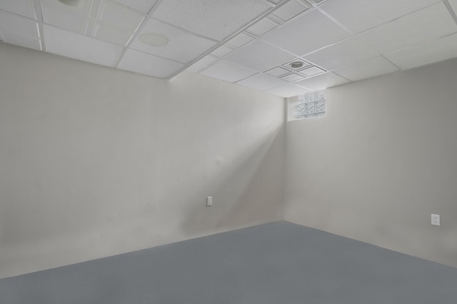 basement with a paneled ceiling