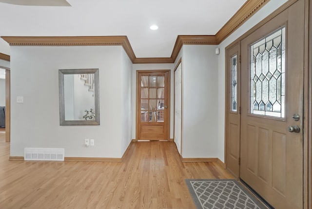 entrance foyer with crown molding and light hardwood / wood-style floors