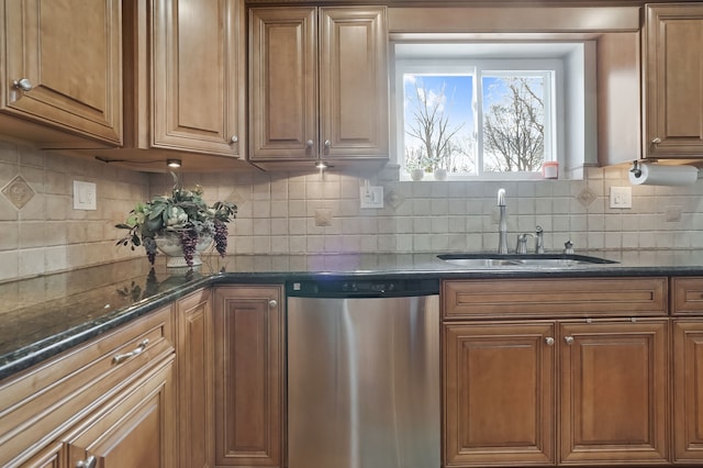 kitchen with dark stone counters, a sink, brown cabinets, dishwasher, and backsplash