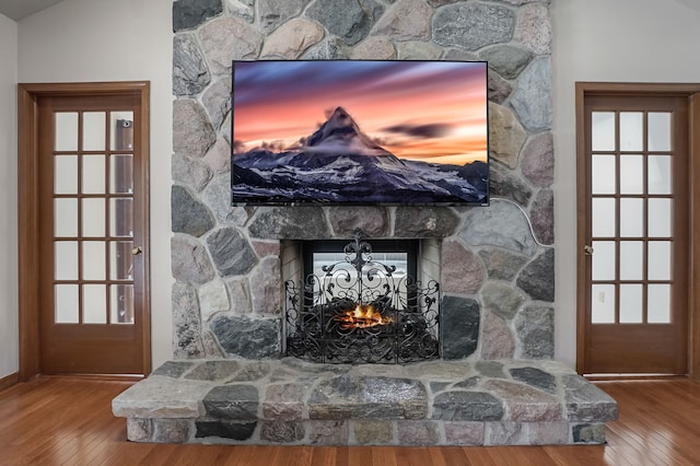 interior details with baseboards, wood finished floors, and a fireplace