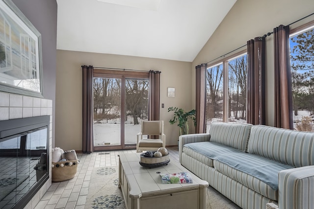 living room featuring lofted ceiling and a healthy amount of sunlight