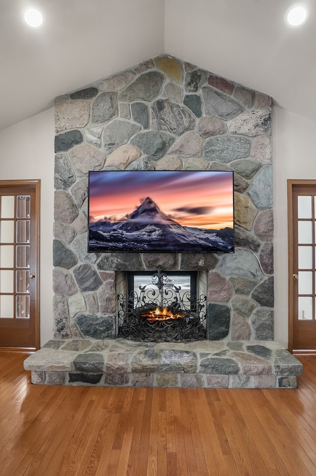 interior details with a stone fireplace and hardwood / wood-style floors