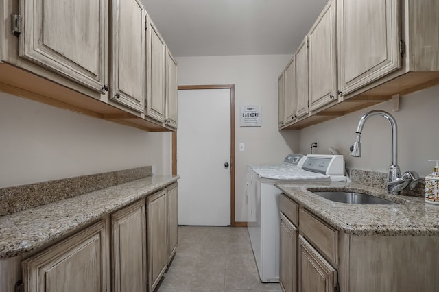 washroom with separate washer and dryer, sink, light tile patterned floors, and cabinets