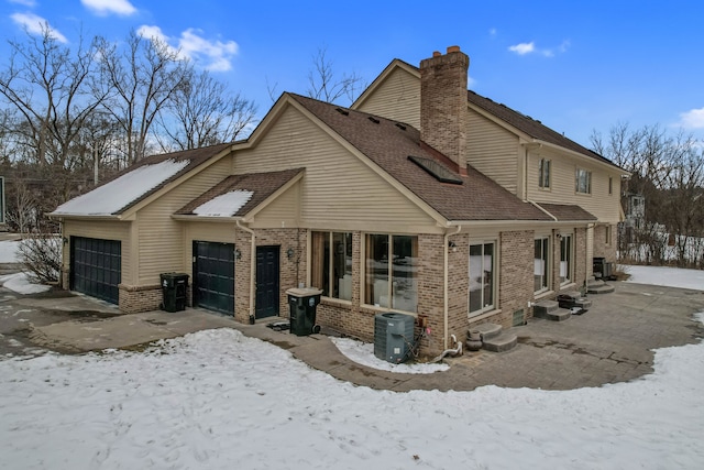 exterior space featuring a garage and central AC