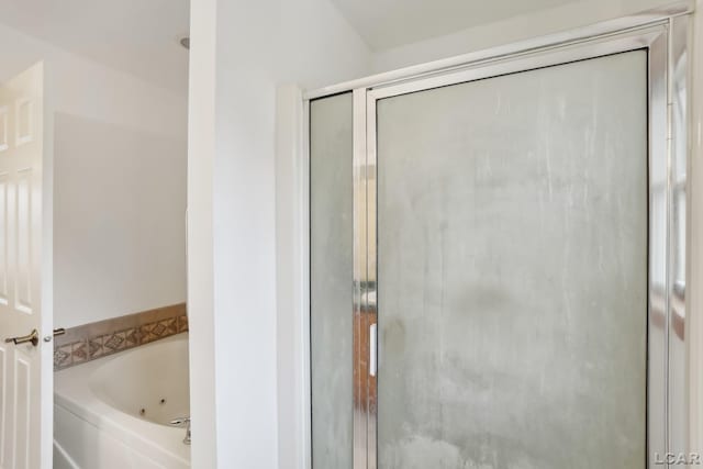 bathroom featuring independent shower and bath