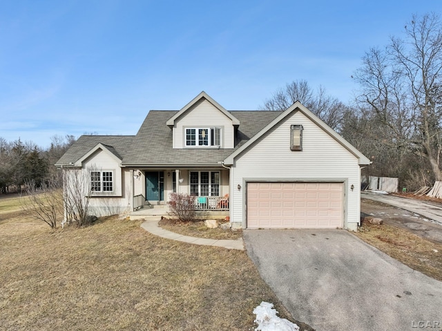 view of front of property with a garage, covered porch, and a front lawn