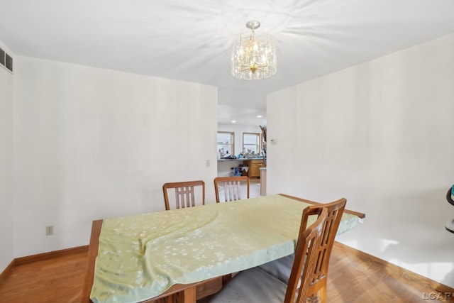 dining area featuring an inviting chandelier and light wood-type flooring