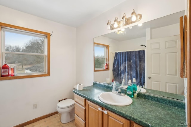 bathroom featuring vanity, toilet, a healthy amount of sunlight, and a shower with shower curtain