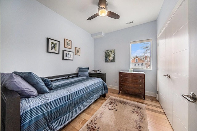 bedroom with ceiling fan and light wood-type flooring