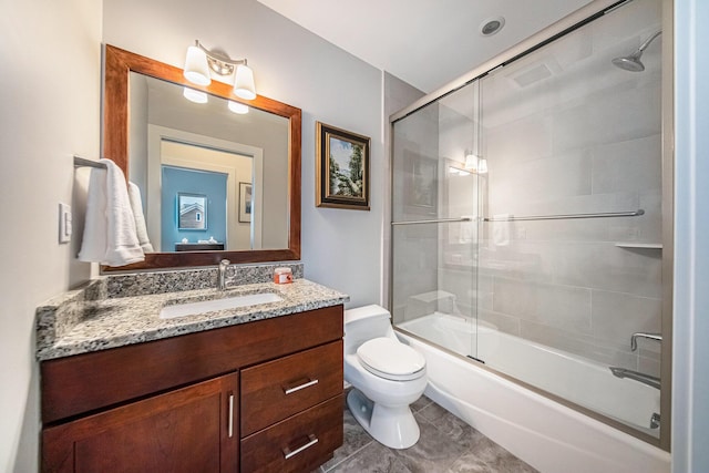 full bathroom with toilet, vanity, and shower / bath combination with glass door