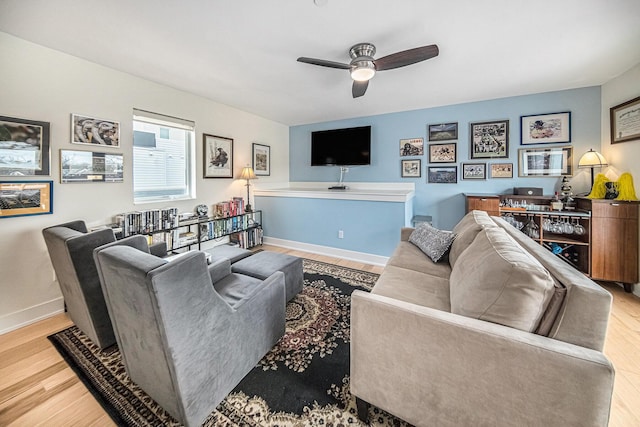 living room with ceiling fan and light hardwood / wood-style flooring