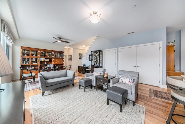 living room featuring ceiling fan and light hardwood / wood-style floors