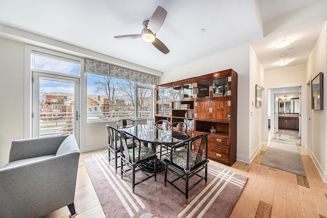 dining area featuring ceiling fan and light wood-type flooring