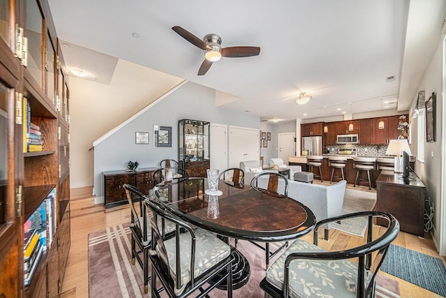 dining space featuring ceiling fan and light wood-type flooring