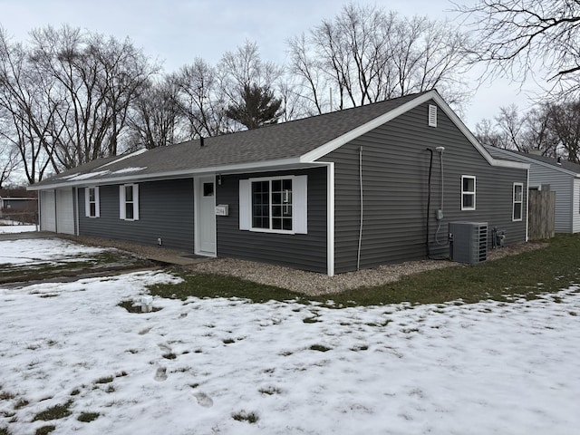 view of front of property featuring central AC and a garage