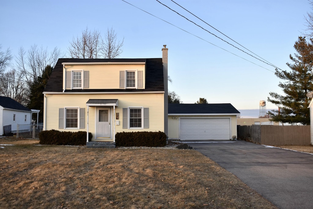 front facade featuring a garage and a front yard