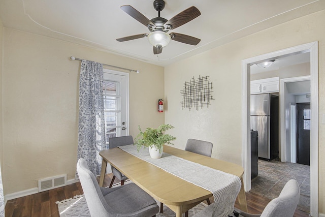 dining space with ceiling fan and dark hardwood / wood-style floors