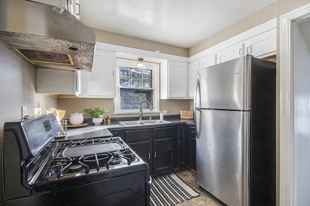 kitchen featuring sink, white cabinetry, stainless steel fridge, range hood, and black gas range