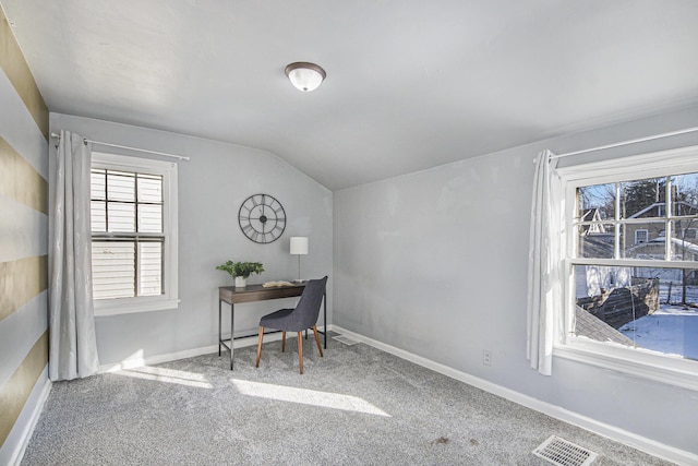 carpeted office space featuring lofted ceiling