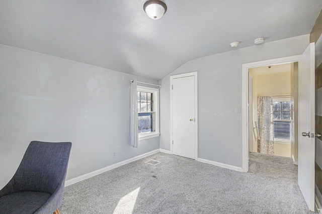 interior space with lofted ceiling and carpet floors