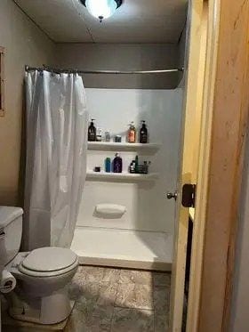 bathroom with toilet and walk in shower